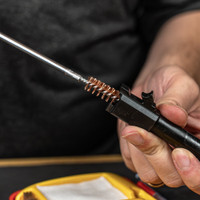 Lifestyle image of image of Shooter's Choice .40 caliber Pistol Cleaning Kit rod and bore brush shown in use