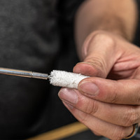 Lifestyle image of image of Shooter's Choice .40 caliber Pistol Cleaning Kit bore mop shown in use