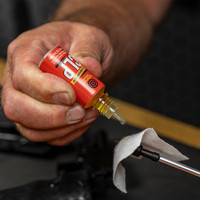 Product lifestyle image of Shooter's Choice FP-10 CLP being applied to a patch and jag for gun cleaning