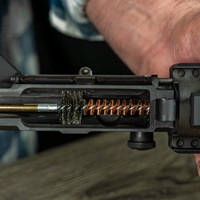 Lifestyle image of  Shooter's Choice Universal Gun Cleaning Kit chamber brush in use
