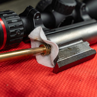  Lifestyle Image of Shooter's Choice Muzzleloader Cleaning Accessory Pack presaturated patches in use on a muzzleloader