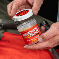 Lifestyle image of Shooter's Choice FP-10 Presaturated CLP Patches lid being removed
