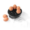 Hand washing black egg poacher accessory at kitchen sink
