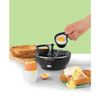 Black electric egg cooker with cooked eggs, poacher, and toast for breakfast