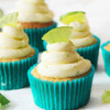 Lime cupcakes with whipped frosting in turquoise paper cases