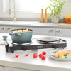 Progress double hot plate with two teal pans cooking, shown on kitchen counter.