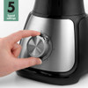 Top view of a clear blender jug showing stainless steel blades
