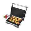 Electric grill with skewers of mixed vegetables and halloumi, ready to cook
