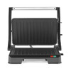 Open electric grill with ribbed black plates, suitable for sandwiches or paninis.