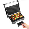 Open electric grill with ribbed black plates, suitable for sandwiches or paninis.