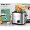 Stainless steel deep fat fryer with black lid on kitchen counter, shown with sauces.