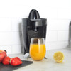 Black electric citrus juicer with transparent lid, Progress branding, product display image