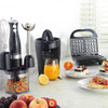 Black electric citrus juicer with transparent lid, Progress branding, product display image