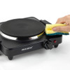 Set of three non-stick frying pans with cooked fish, chicken, omelette, and vegetables.