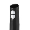 Black stick blender attachment held above clear glass bowl with avocado and herbs