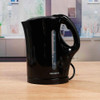 Black electric kettle with water level window on kitchen worktop