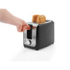Black 2-slice toaster with wavy design, hand lowering lever, seeded bread inside