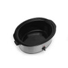 Hand turning dial on stainless steel slow cooker to high setting