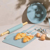 Light blue baking utensil set with rolling pin, spatulas, and cake tin, shown with croissants and eggs