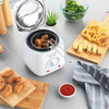 White electric deep fryer with temperature dial on kitchen shelf