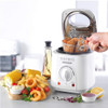 Compact white deep fat fryer with basket of breaded chicken, vegetables and chips on countertop