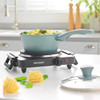 Teal saucepan with vegetable pasta on black electric hot plate, Progress branding visible