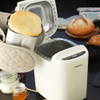 White Progress bread maker with loaf in pan, shown on a kitchen counter