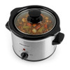 Silver slow cooker with black lid, filled with stew, viewed from above