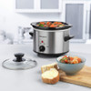 Stainless steel slow cooker with black ceramic pot and glass lid shown separated