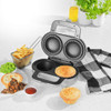 Electric pie maker with two golden pies, shown with steak pie, chips and mushy peas