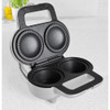 Silver double pie maker with open lid showing non-stick baking plates on kitchen counter