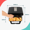 Black sandwich toaster with four toasted sandwiches in a modern kitchen