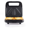 Black sandwich toaster open with two toasted sandwiches, shown on kitchen surface.