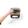 Hand opening black waffle maker with two cooked waffles, top-down view