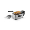 Silver deep fat fryer with basket of cooked chips, lid beside unit