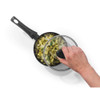 Black saucepan with glass lid, shown cooking tagliatelle pasta with pesto, pine nuts and herbs