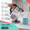 Glass kettle pouring hot water into a mug