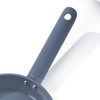 Non-stick blue frying pan showing textured handle and part of pan from above