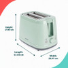 Green two-slice toaster with bread being inserted, shown on a kitchen counter