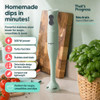 Green hand blender on kitchen counter with tomato soup and sliced bread