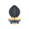 Electric omelette maker with two cooked omelettes in blue appliance