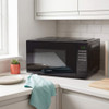Black digital microwave oven on kitchen counter