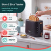 Black 2-slice toaster in modern kitchen, hand lowering toast into slot
