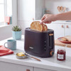 Black 2-slice toaster in use on kitchen counter with two pieces of bread