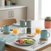 Pair of Progress salt and pepper mills in green on breakfast table setting