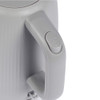 Close-up of grey electric kettle handle showing power button