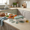 Green vegetable chopper with interchangeable blades on kitchen worktop