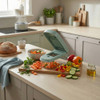 Green vegetable chopper with diced carrots, peppers and cucumber on kitchen counter