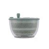 Green salad spinner with clear bowl and lid, shown from the side.