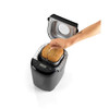 Black bread maker with freshly baked loaf, shown from above, lid open